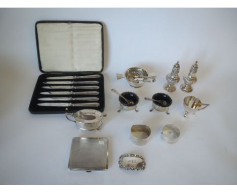 Qty of mixed hallmarked silver salts, pepper pots, napkin rings, cigarette case etc. 15oz  well used and showing signs of war