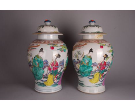  Pair of Chinese famille rose baluster vases and covers, each painted on the front with a lady playing flute accompanied by h