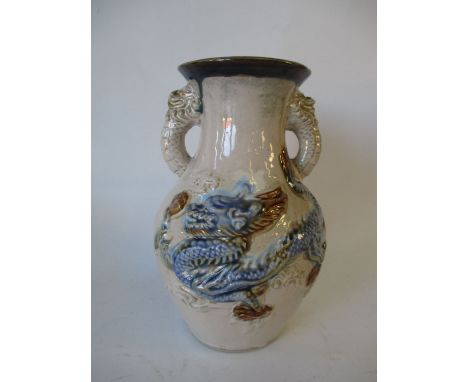 Early C20th art pottery vase with raised dragon decoration the handles as dragons heads  Good general condition