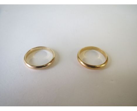 Two gold coloured metal wedding bands. size m/n. 6g 