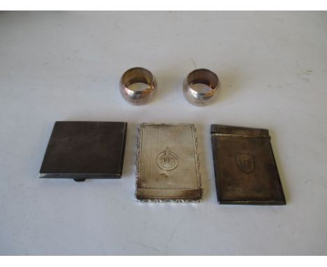 Two hallmarked silver card cases, silver hallmarked cigarette case and a pair of silver napkin rings. 8ozt or weighable silve