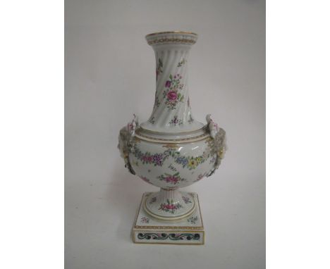 Samson vase with narrow neck decorated flowers and an armorial, the handles as two female faces on a square base  Chips to th