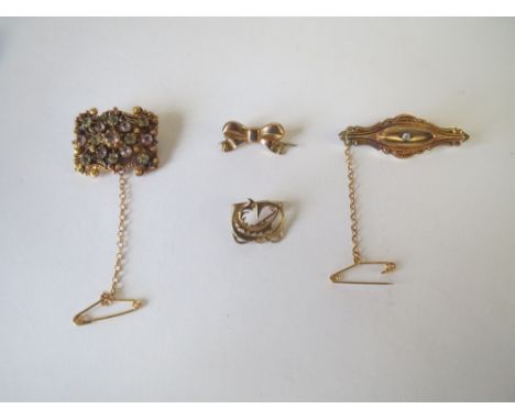 Four gold metal brooches. 12.5g 