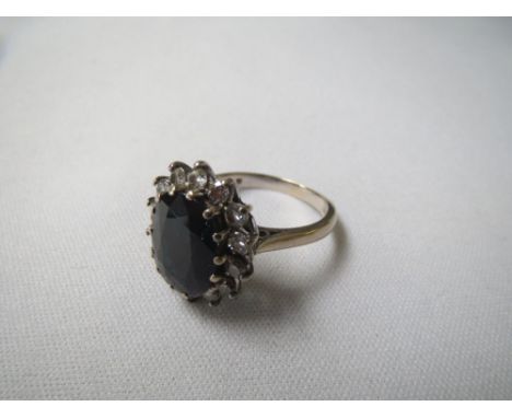 One dark blue sapphire and diamond cluster ring set in 18ct white gold, sapphire weight approx 5cts 