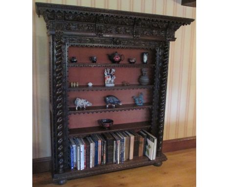 Large antique French ornately carved oak open bookcase with four adjustable shelves. Flanked by barley twist columns beneath 