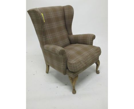 Modern wing back armchair upholstered in dark and light brown check fabric  well used, showing signs of wear to fabric and ma