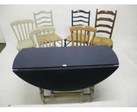 Decorative painted drop leaf gate leg table, three rush seat chairs and two other decorative chairs well used, showing signs 