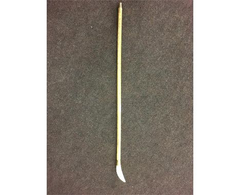 Whale Bone Walking Stick, with Whale Bone Tooth Head. The length of the item is approximately, 34 Inches, the shaft to the ey
