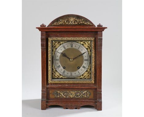 Early 20th Century oak bracket clock, Camerer Kuss & Co New Oxford St, the arched top with gilt metal swag pediment above a s