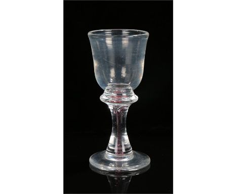 Late 18th Century drinking glass, with bell shaped bowl resting on a cushion raised on a column from the foot, the column has