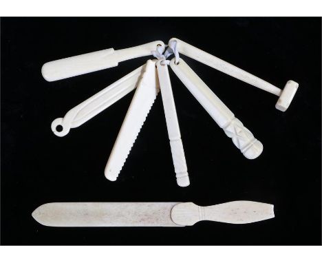 Six bone teething tools, to include a saw, a cricket bat and a mallet, together with a bone paper knife, (7)