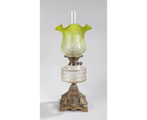 Victorian oil lamp, with a green glass shade above a glass reservoir and gilt metal base, 56cm high