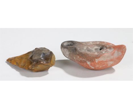 Late Roman/Byzantine oil lamp, with a central crucifix and geometric design to the edge, 13cm long, together with a Neolithic