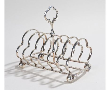 Victorian Silver six slice toast rack, London 1898, makers William Hutton & Sons Ltd, with loop finial, shaped divisions, on 