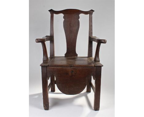 George III oak armchair, formally a commode, the arched top rail above a splat back and shaped arms, solid seat and square se