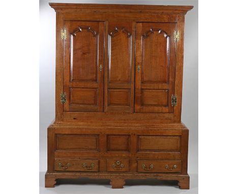 18th Century oak cupboard, the concave cornice above a pair of fielded panel doors enclosing shelves, the base section with p