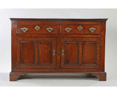 Oak sideboard, the rectangular top above two frieze and two fielded cupboard doors raised on bracket feet, 137cm x 63cm x 87c