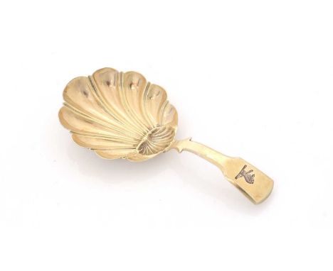 A George III caddy spoon, silver gilt on the front, white on the reverse, initialled "MR", with a fluted shell bowl and a fid