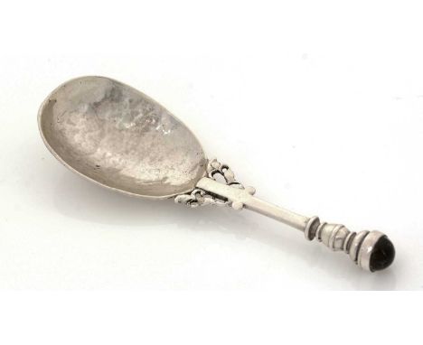A George V silver hand-made caddy spoon, with hammered egg-shaped bowl and decorative pierced buttresses at the junction of t