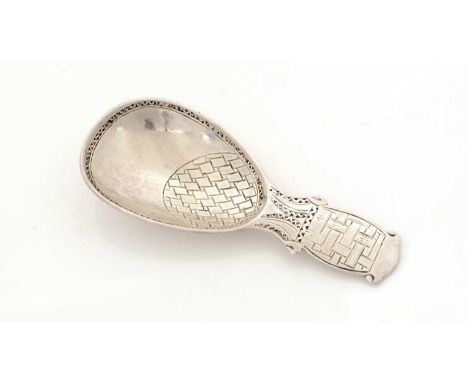 A George V silver caddy spoon, with an egg-shaped bowl and short shaped stem decorated with panels of geometric engraving, by