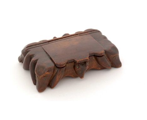 A 19th Century carved wooden snuff box, with hand and fox masks in relief around the sides, 10.7cms long.