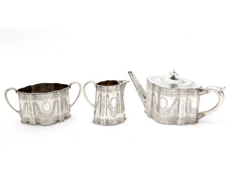 A Victorian silver three-piece tea service, of shaped oval outline with bright-engraved decoration, bead borders and C-scroll
