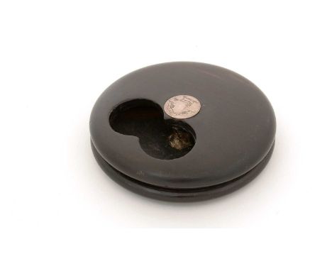 A 19th Century dark hardwood snuff box, circular with a rotating cover and an aperture to facilitate taking a "pinch" of snuf