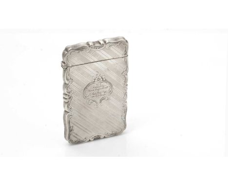 A small Victorian silver card case, of shaped rectangular outline with an engraved scroll border, diagonally striped engine t