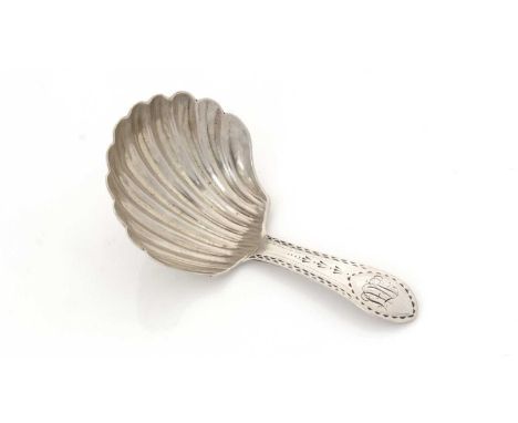 A George III Irish silver caddy spoon, with fluted shell bowl and an engraved "Celtic point" stem, initialled, by Jonas Osbor