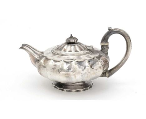 A George IV silver teapot of squat circular form, on shaped circular foot with a similarly shaped body, a ribbed knop finial 