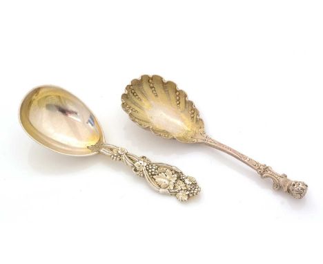 A Victorian silver caddy spoon, with a gilt bowl, chased decoration and a female bust terminal, by George Adams, London 1877;