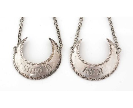 A pair of George III silver wine labels, each in the form of a crescent with feather-edging, incised "RUM" and "SHRUB", maker