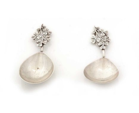 A matched pair of two very similar silver caddy spoons, with drop-shaped bowls and a sprig of shamrock forming the stems, one