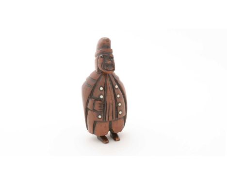 A 19th Century Continental carved coquilla nut snuff box, in the form of a courtly figure with a tailcoat, a buttoned waistco