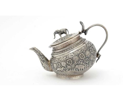 A late 19th/early 20th Century Indian silver teapot, globular with an offset foot, an elephant finial and a C-shaped handle i