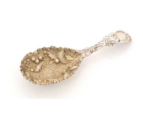 A Victorian silver cast caddy spoon, with a chased stem and a vacant cartouche, the gilt bowl with diaperwork in the centre b