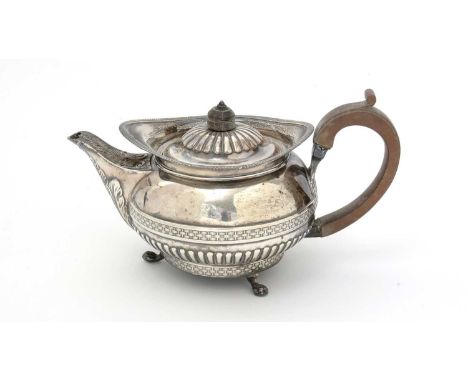 A George III silver teapot, with a squat circular body and a "cape" rim, decorated with basketweave borders and part fluting 