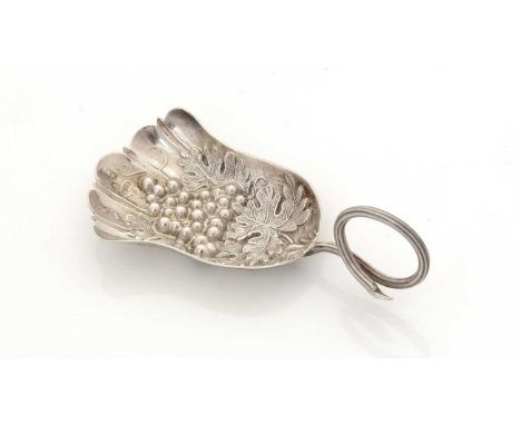 A William IV silver caddy spoon, with a reeded tendril handle and a fan-shaped bowl, embossed and chased with fruiting vines,