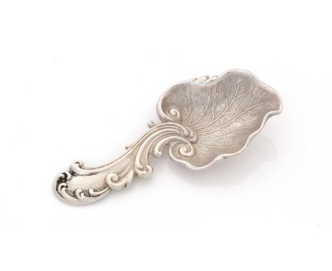 A Victorian silver Provincial caddy spoon, stamped with a leaf bowl and a scrollwork stem, by Aaron Hadfield, Sheffield 1849,