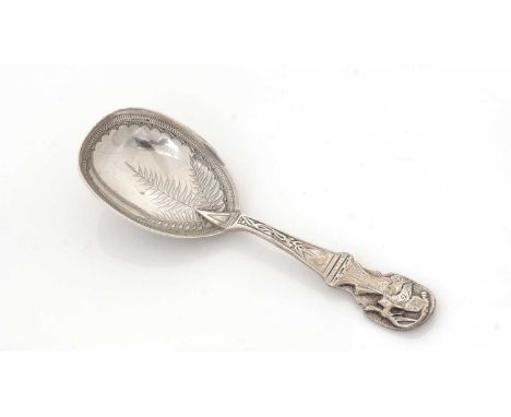 A Victorian silver caddy spoon, in the Japanese taste, with an applied Bijin figure on the terminal and engraved ferns, bambo