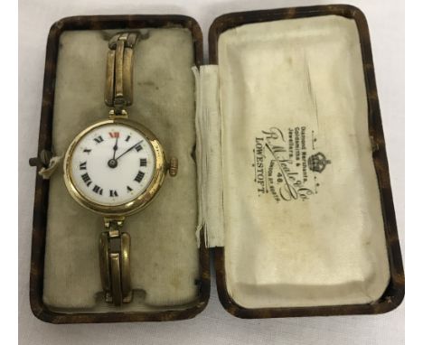 A vintage wristwatch with rolled gold expanding bracelet strap. Enamel face with roman numeral hour markers. 