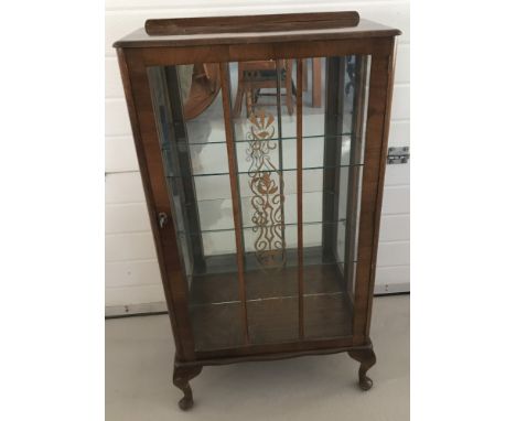 A small vintage glass door display cabinet with interior glass shelves. On small cabriole legs and complete with key. Approx.