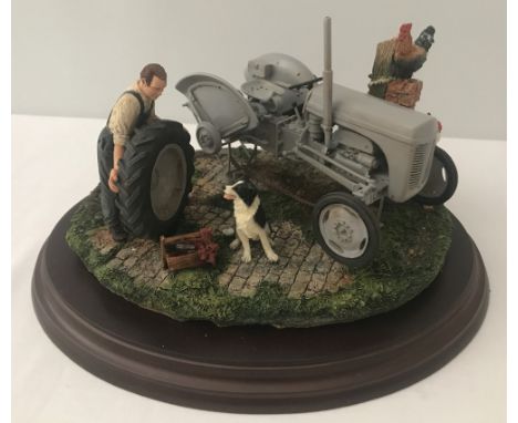 A Country Artists sculpture "Widening The Track" by Keith Sherwin. Model number 01909. Depicting a farmer changing the wheel 