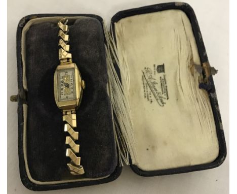 A ladies vintage wristwatch with rolled gold case. Greek key decoration to sides of case. Excalibur expanding gold tone strap