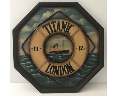 A vintage Octagonal wooden wall hanging plaque with a 3D life buoy and hand painted Titanic detail.  Approx. 62cm t x 62cm w.