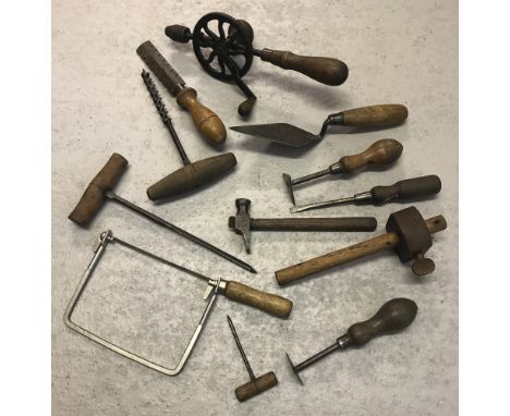 A tray of assorted vintage hand tools many with wooden handles. To include hand drill, scrappers, guage and gimlets. 