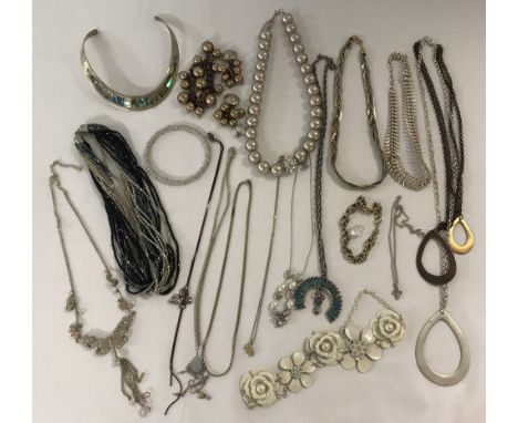 A small collection of vintage and modern costume jewellery. To include necklaces, bracelets and a paua shell inlaid white met