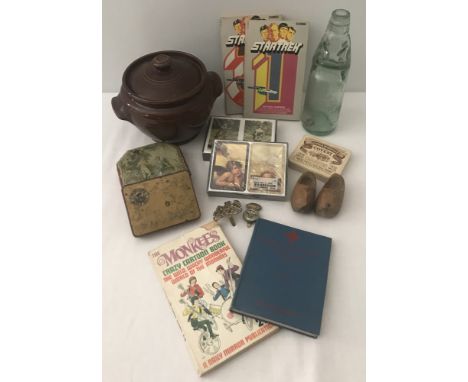 A collection of mixed items to include military badges, vintage tins and Harrods playing cards.  