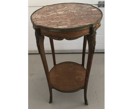 A vintage marbled topped wooden framed jardinière stand with brass overlay detail. Some damage to top. Approx. 76cm tall x 47