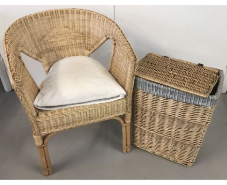 A modern light wood basket chair together with a fabric lined linen basket with lift up lid.  